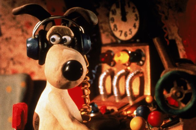 Gromit the dog looks over his shoulder whilst at the console of a rocket.