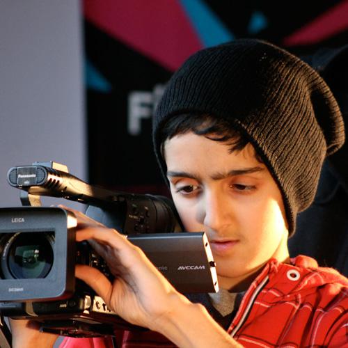 A young workshop participant learning filmmaking skills at Watershed