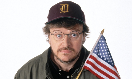 Michael Moore holding the US flag.