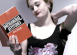 A young woman reading a book on 'patriarchal issues'