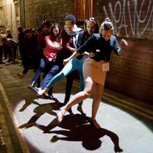Girls dancing under a street lamp