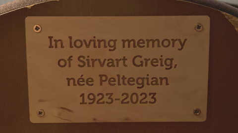 A plaque in memory of a loved one on the back of one of Watershed's cinema seats.