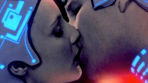 Scene from Ton - a  couple dressed in neon headgear kissing.