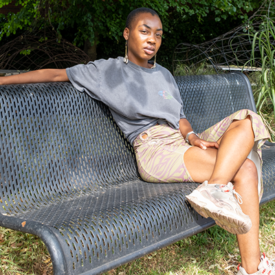 Portrait of Jillisa sitting on a park bench