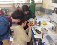 Luke, Oliver and Abigail testing the micrometeoroid detector as they attach it to the cubesat