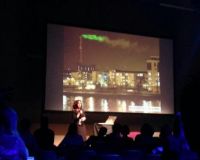 Verity talking about projecting energy usage figures onto smoke from a powerstation - photograph by @bengood