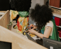 Image of artist Shrouk El-Attar building a robot at the Pervasive Media Studio.