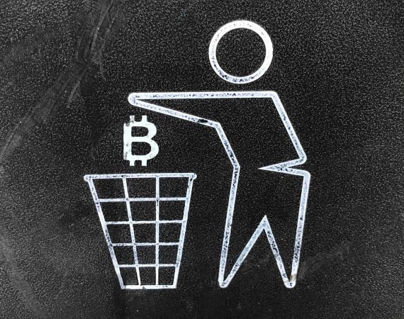 A drawing of the bitcoin logo being dropped in a rubbish bin