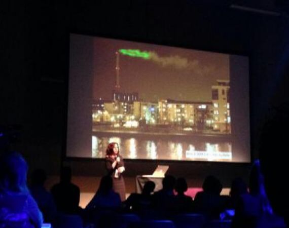 Verity talking about projecting energy usage figures onto smoke from a powerstation - photograph by @bengood