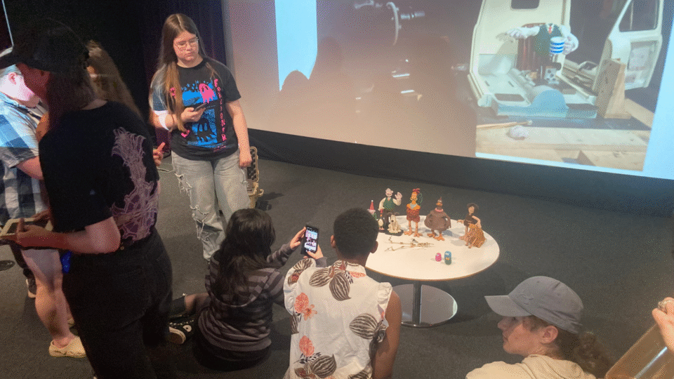 Students looking at and capturing footage of models featured in Aardman Animations