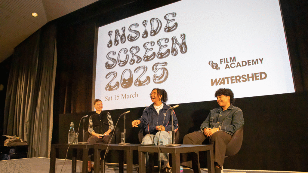 Jess Wheeler, Shakira Newton and Alysha Christal in discussion, sat behind microphones and in front of Inside Screen 2025 visual