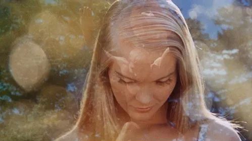 Still from The Swimmer, a man diving into a pool superimpose with a woman's head looking down.