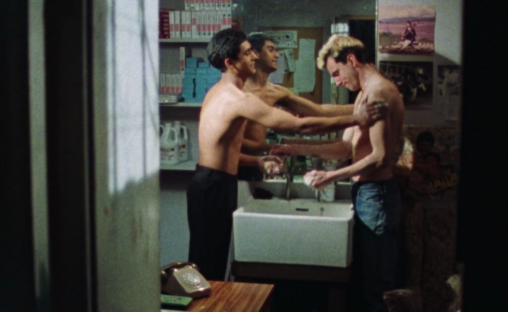 Gordon Warnecke and Daniel Day-Lewis, topless and bathing each other.