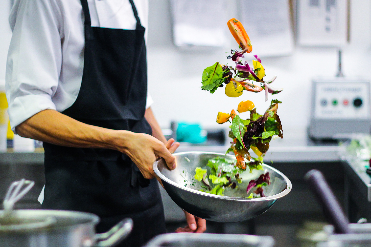 Photo of a chef cleaning salad at Watershed
