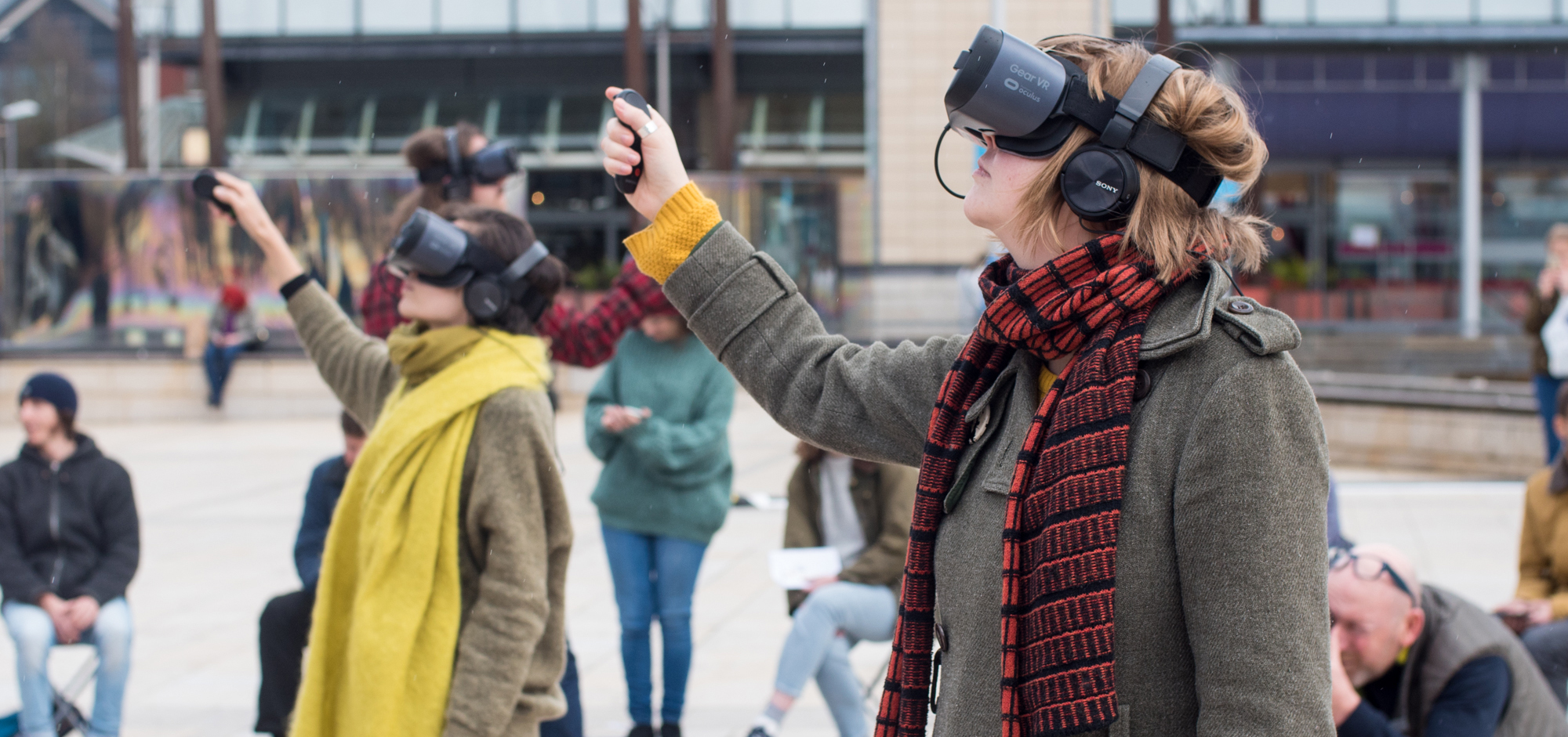 People with VR Goggles on standing in a square