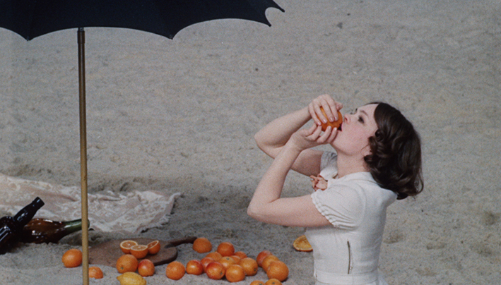 Woman eating fruit on beach