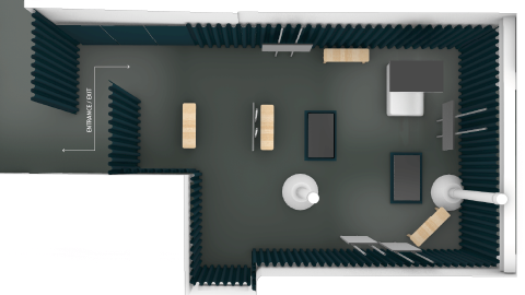 The layout of the FRAMERATE exhibition which has multiple screens placed around a dark room with wooden benches and black curtains around the edge.