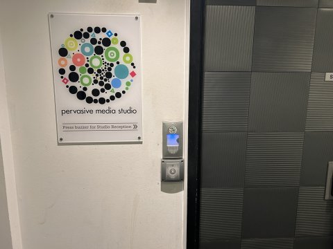 Photo of the buzzer next to the double doors to the Pervasive Media Studio.