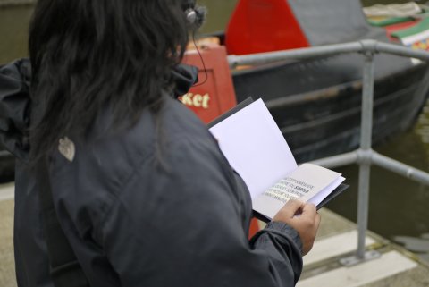 A person with dark hair has the Only Expansion guidebook open.
