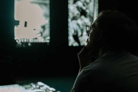 A person peers over at a screen during FRAMERATE.