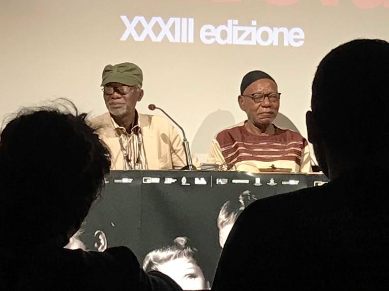 Filmmakers Soulymane Cissé and Jean-Pierre Dikongué Pipa at Il Cinema Ritrovato.