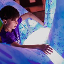 A child hugging a robotic inflatable
