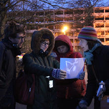 People exploring projected map in Give Me Back My Broken Night