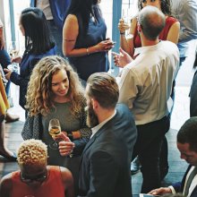 Photo pf people chatting and networking at a Watershed business event.