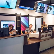 Three Watershed team members smiling into the camera at Box Office