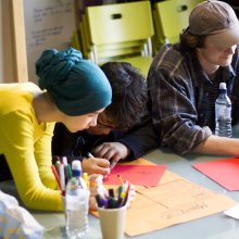 Three creatives collaborating at a workshop