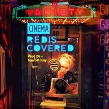 A still from Variety. A woman stares out of a glass windowed booth, tentatively. Graphic title card reads: Cinema Rediscovered.