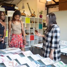 A photo of three people at First Friday in Watershed's Pervasive Media Studio.