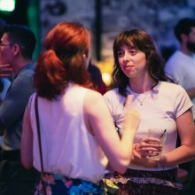 Two women in conversation at a networking event
