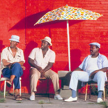 Three men on the sidewalk