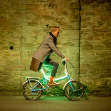 Man on illuminated bike