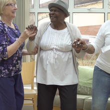 Three women dancing and smiling