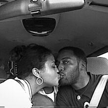 Woman and man kissing in a car