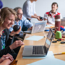 Photo of transducers workshop with five artists participating around a table.