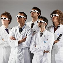 5 men in lab coats and 3d glassess looking up