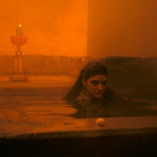 Photo of a woman in candlelight in a steam room