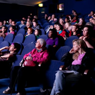 Photo of an audience in Watershed cinema engrossed in a film screening