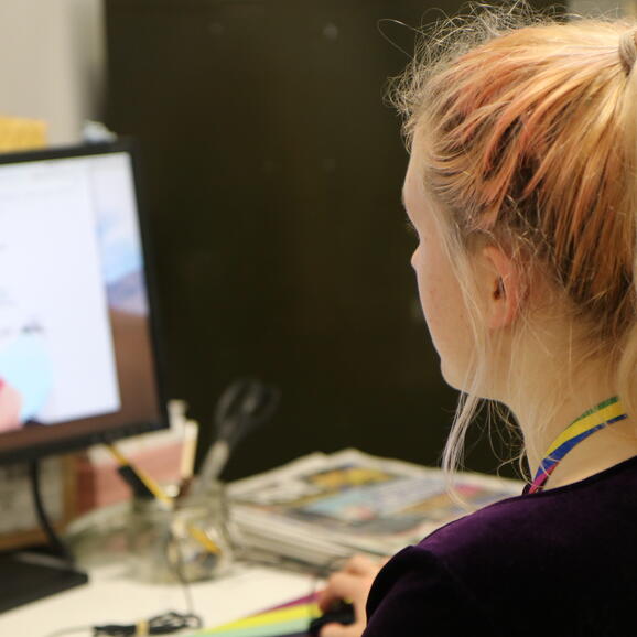 Woman working at desk on computer