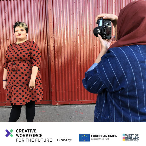 Two women, one being photographed, one taking the picture.