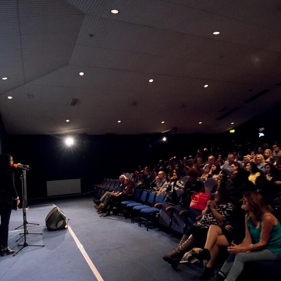 Cinema auditorium with audience and speakers