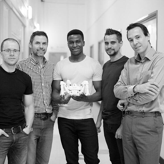 Silas (centre) with the Reach Robotics team and a Mecha Monster Silas (centre) with the Reach Robotics team and a Mecha Monster