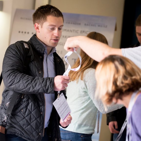 Photo of a man registering at a conference at Watershed