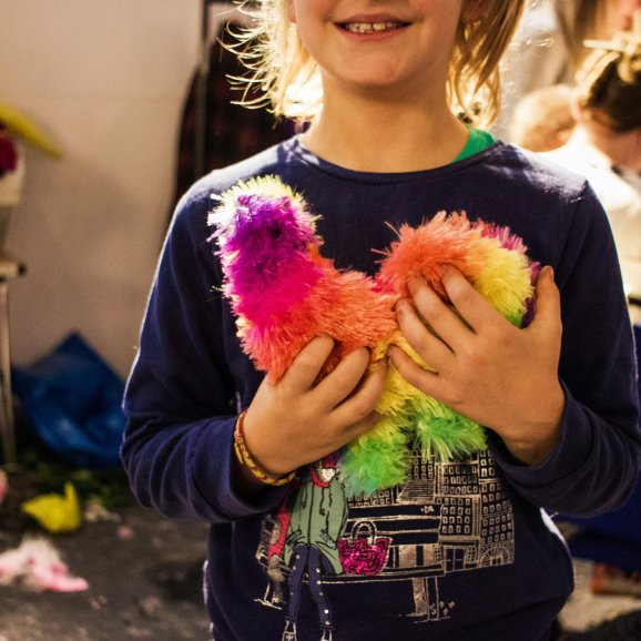 Anonymous photo of a child cuddling a colourful toy
