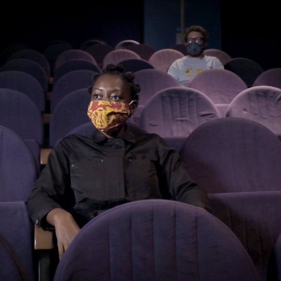 Photo of 2 customers in Watershed cinemas wearing face coverings