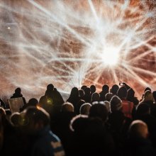 Crowds of people watching a light show.