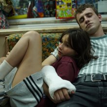 Girl and man asleep on a seat